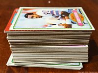 Stack of vintage football cards showing thickness and edge conditions.