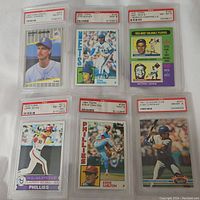 Lot of six graded baseball cards displayed in protective plastic holders, showing player images and PSA grade labels
