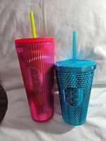 Both pink and blue Starbucks tumblers shown side by side on light background