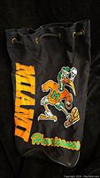 Front view of black vintage Miami Hurricanes drawstring bag showing colorful mascot and team name print