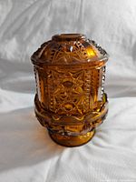 Side view of amber glass fairy lamp showing detailed pressed glass star and geometric patterns