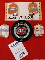 Four Montreal Canadiens jersey fridge magnets with season years and one official NHL game puck with Montreal Canadiens logo.