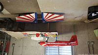 Red Super Star model airplane fuselage laid out on table with parts and separately placed wings with patriotic design