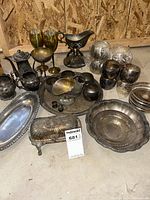 Wide shot of entire lot, showing all items arranged on floor against plywood wall