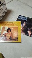 Two vinyl album covers: Arlo Guthrie 'Alice's Restaurant' and The Rolling Stones 'Aftermath'
