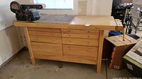Woodworkers bench with multiple drawers and solid wood top
