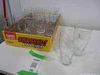 Set of 12 clear glass beer glasses in a cider branded cardboard tray