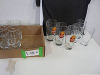 3 Ontario Beer Week glasses with color logos and additional glasses.