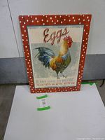 Front view of the canvas print showing the rooster and text with a red polka dot border.