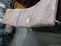 Photo of large lounge cushion with patterned fabric on metal frame