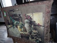 Full view of wine theme tapestry showing still life with wine bottle and grapes against a rustic backdrop, mounted on metal rail, with the tapestry draped and some visible texture.