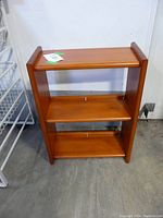 Front view of maple wood shelf showing two shelves and overall structure against a white backdrop.
