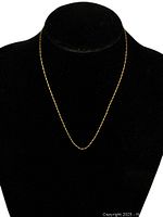 Chain displayed on black velvet bust to show length and design.