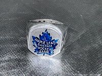 Front view of the silver-tone Hockey Club ring with blue enamel maple leaf and inscription