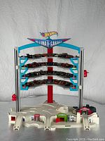 Full front view of Hot Wheels Ultimate Garage playset including ground level and four elevated parking levels occupied by multiple vintage cars.