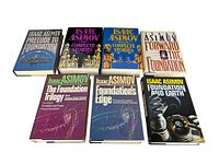 Front covers of all 7 books including The Complete Stories Volumes 1 & 2 and Foundation series books showing vibrantly colored dust jackets with sci-fi artwork.