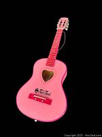 Front view of the pink Schoenhut children's acoustic guitar showing six strings with one broken, heart-shaped sound hole, and pink fretboard.