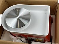 Vevor pottery wheel inside original shipping box showing metal wheel head and white drip tray.