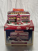 Photo of vintage porcelain lighted house Al's Diner on original box showing front and top views