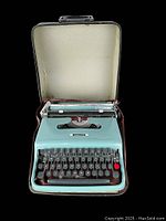 Front view of vintage Underwood Olivetti Lettera 22 portable typewriter inside open carrying case with wear and discoloration.