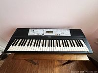 Top angle of Yamaha YPT-200 electronic keyboard showing full keyboard and control panel.