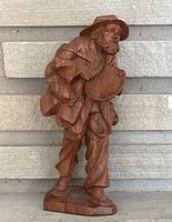 Front view of the vintage hand carved wooden hobo figurine showing detailed carving of the man's clothing and face, standing barefoot.