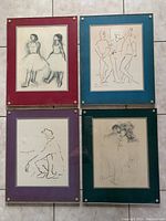 Four framed art prints with colored mats: two pencil sketches of dancers, two line drawings of human figures, all mounted under plexiglass with brass screws