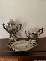 Full set including coffee percolator, teapot, and small dish shown on table with plain background