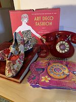 Classic red rotary phone next to slippers, calendars and photo albums