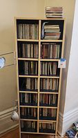Full view of the wooden shelving unit holding the CDs, showing the size and amount of CDs stored.