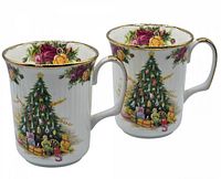 Pair of white fluted mugs with gold trim, decorated with Christmas tree, presents, and Old Country Roses floral motifs