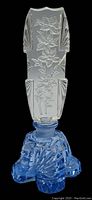 Side view of blue crystal perfume bottle showing detailed floral design on clear crystal stopper and faceted body with cut designs.