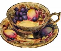 Close up of hand painted cup and saucer with fruit design and gold trim, showing detailed brushwork and vibrant colors