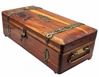 Angled side view showing wooden box with brass corner bindings and side handle.