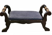 Front angled view showing dark wooden frame, upholstered cushion with diamond pattern, and scrolled legs and ends