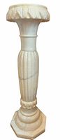 Full view of alabaster pedestal showing overall shape, design, material
