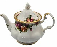 Angled front view of teapot with lid showing handle, spout, floral pattern, and gold trim
