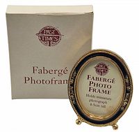Miniature Fabergé enamel photo frame shown from the front alongside its original Past Times box, showing size and design details.