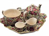 Full view of set on tray showing teapot, cup, creamer and sugar bowl