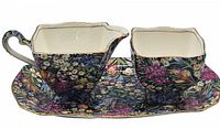 Three-piece Royal Winton Grimwades set with floral decoration on tray, creamer, and sugar bowl