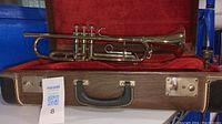 Full view of Cleveland Superior trumpet resting in its red velvet-lined wooden carrying case featuring metal latches and leather handle.