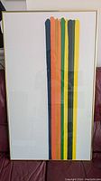 Full view of the framed Morris Louis COLOR LINE print showing vertical multicolor stripes and thin gold frame.