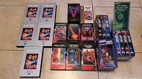 Full collection of Star Trek VHS tapes laid out on floor including boxed sets and individual tapes.