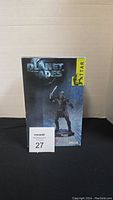 Front view of Neca Planet of the Apes Attar figurine box with labeled sticker