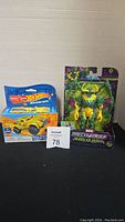 Photo of Mega Hot Wheels Baja Truck building set and Marvel Mech Strike Monster Hunters Loki action figure side by side.