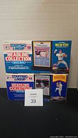 Two boxed Starting Line Up Nolan Ryan Headline Collection Sports Stars sets with collectible headlines and figures visible.