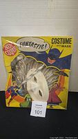 Photo of vintage Ben Cooper costume box with colorful superhero artwork and visible white mask inside.