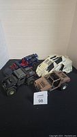 All 4 vintage GI Joe vehicles arranged on a black surface showing overall condition and different models.