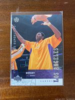Front image of Kobe Bryant in Los Angeles Lakers warm-up jersey on 2002-03 Upper Deck card #119.