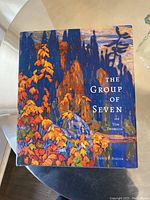 Photo of the book titled 'The Group of Seven and Tom Thomson' by David P. Silcox, showing its colorful illustrated cover.